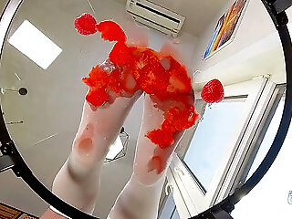 My Nylon Feet Squeezing Strawberry Juice On A Glass Table